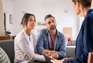 Estate sale professional supporting couple